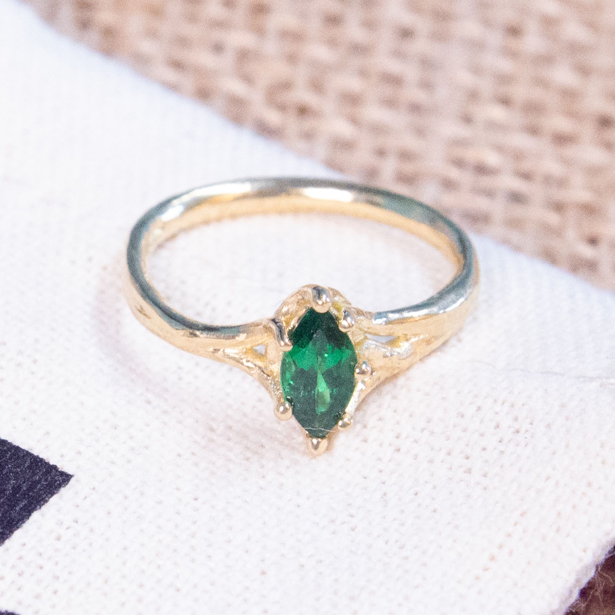 Bespoke three stone engagement ring with an oval diamond, pear side stones and loose diamonds on jewellery design sketches in a goldsmith's workshop