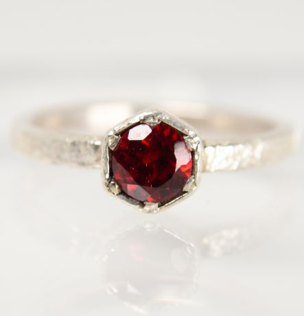 Handmade silver Strykke ring featuring a RED GARNET gemstone in a minimalist silver setting, photographed on a white background