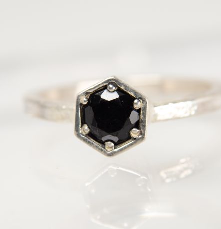 Handmade silver Strykke ring featuring an onyx gemstone in a minimalist silver setting, photographed on a white background