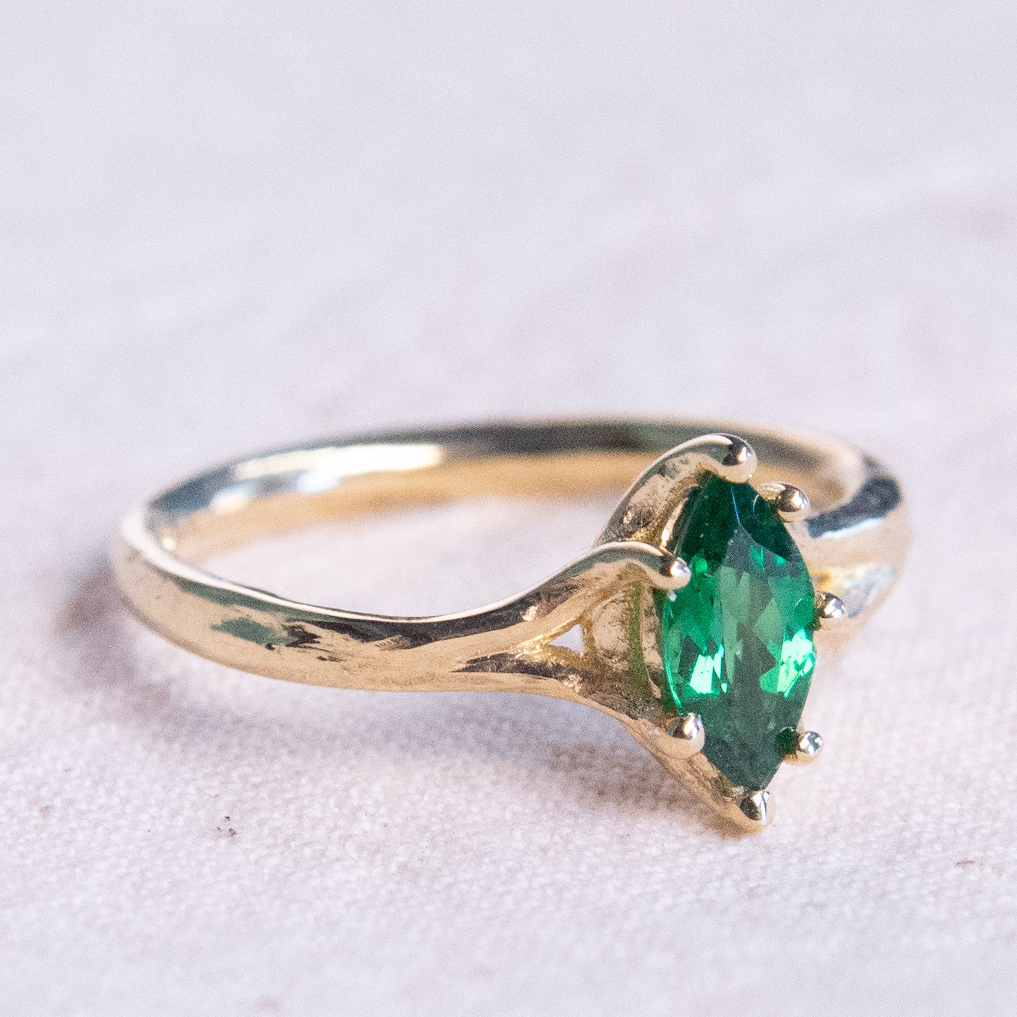 Handmade platinum engagement ring featuring an oval centre diamond with pear shaped diamond side stones and diamond set shoulders