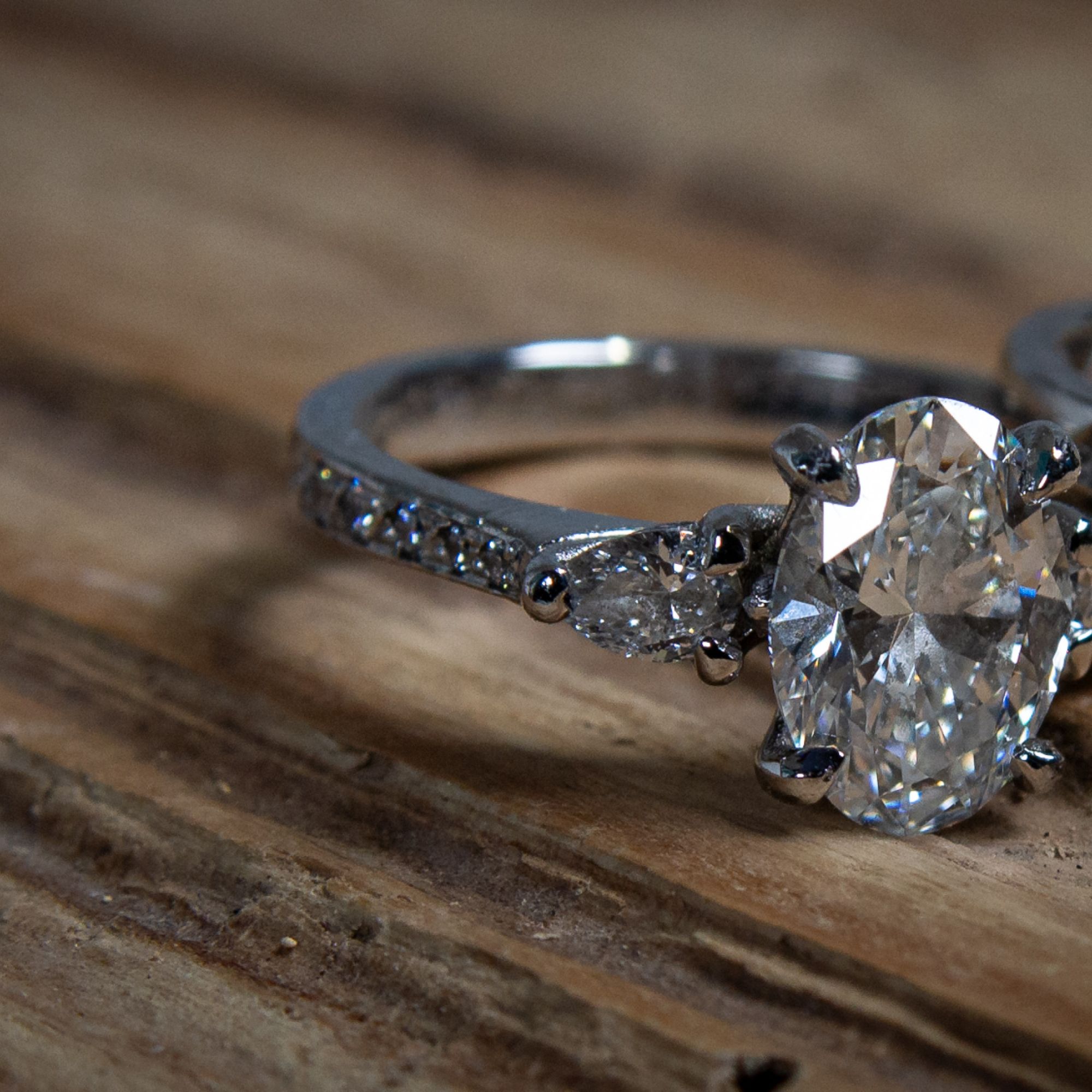 Bespoke oval diamond engagement ring and matching diamond wedding band handmade by Tom McDanielson at The Middle Green studio in Wiltshire