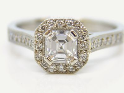 Handmade platinum engagement ring featuring an emerald cut diamond in a four claw setting by The Middle Green.