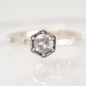 Handmade silver Strykke ring featuring a rose quartz gemstone in a minimalist silver setting, photographed on a white background