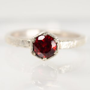 Handmade silver Strykke ring featuring a RED GARNET gemstone in a minimalist silver setting, photographed on a white background