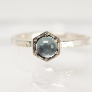 Handmade silver Strykke ring featuring AN AQUAMARINE gemstone in a minimalist silver setting, photographed on a white background