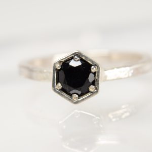 Handmade silver Strykke ring featuring an onyx gemstone in a minimalist silver setting, photographed on a white background