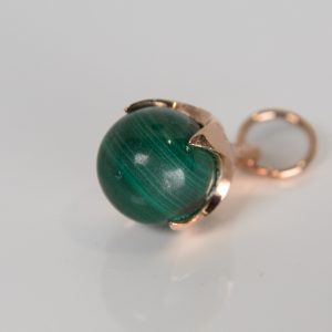 9ct rose gold Ferian pendant with malachite bead on white background
