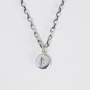 Seidr Frum Charm in recycled sterling silver stamped with the Ansuz rune, a small tactile pebble talisman handcrafted in Wiltshire