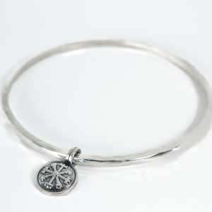 Sterling silver Lagu bangle with Vegvisir charm on white background