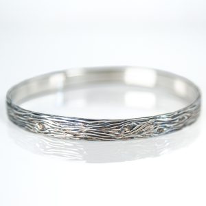 Sterling silver 6mm wood grain bangle textured wide band on white background
