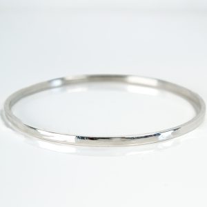 Sterling silver Lagu bangle smooth hammered texture on white background