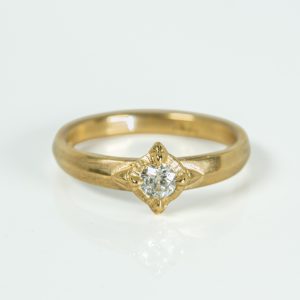 True North 9ct yellow gold engagement ring featuring a 0.30ct old cut diamond in a compass-inspired setting